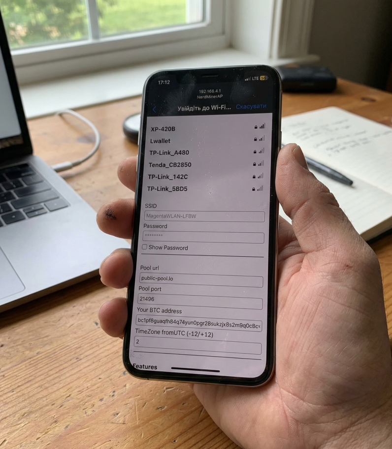 NerdMiner V2 8 Smartphone in hand with Nerdminer V2 settings