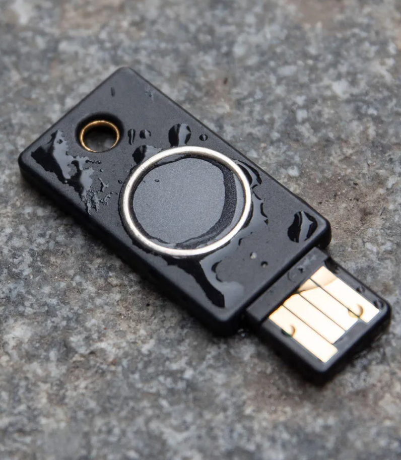 Yubikey Bio on ground with water on it