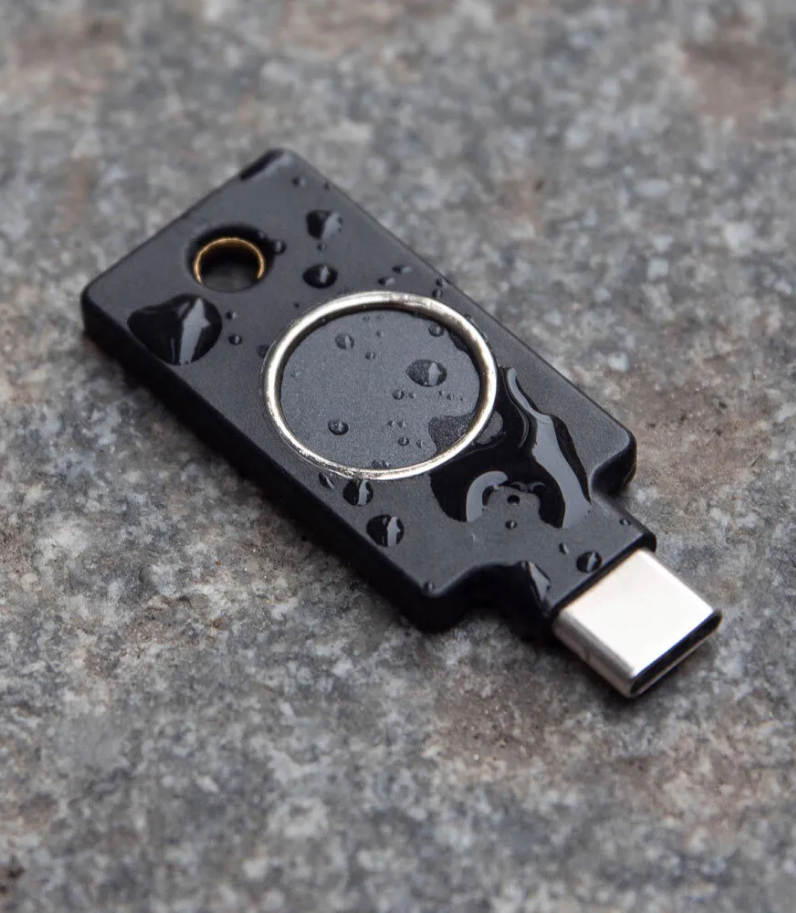 YubiKey C Bio 11 Yubikey C Bio on ground with water on it