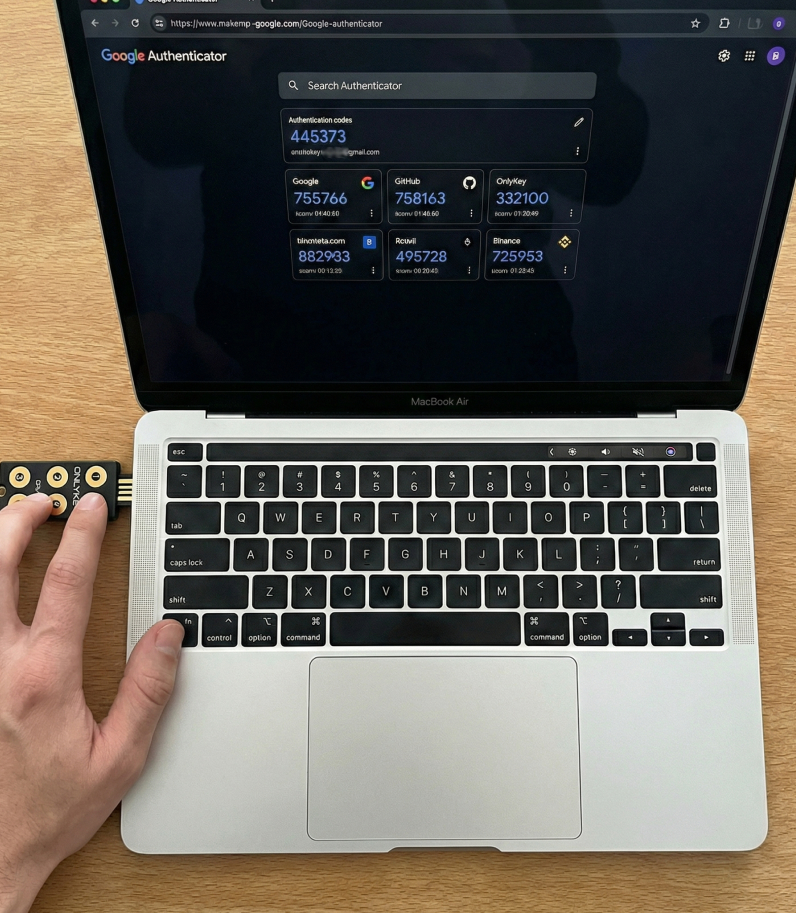 OnlyKey Fido2 insert in laptop and human hand touching it