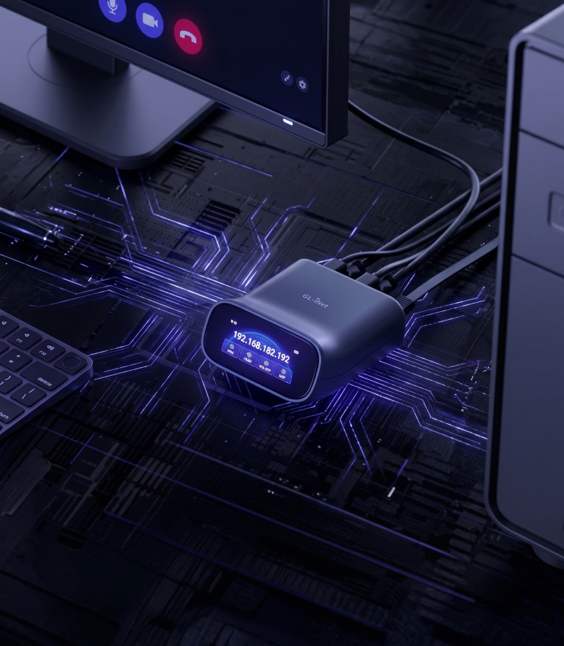 Glinet Comet Pro on desk behind the pc