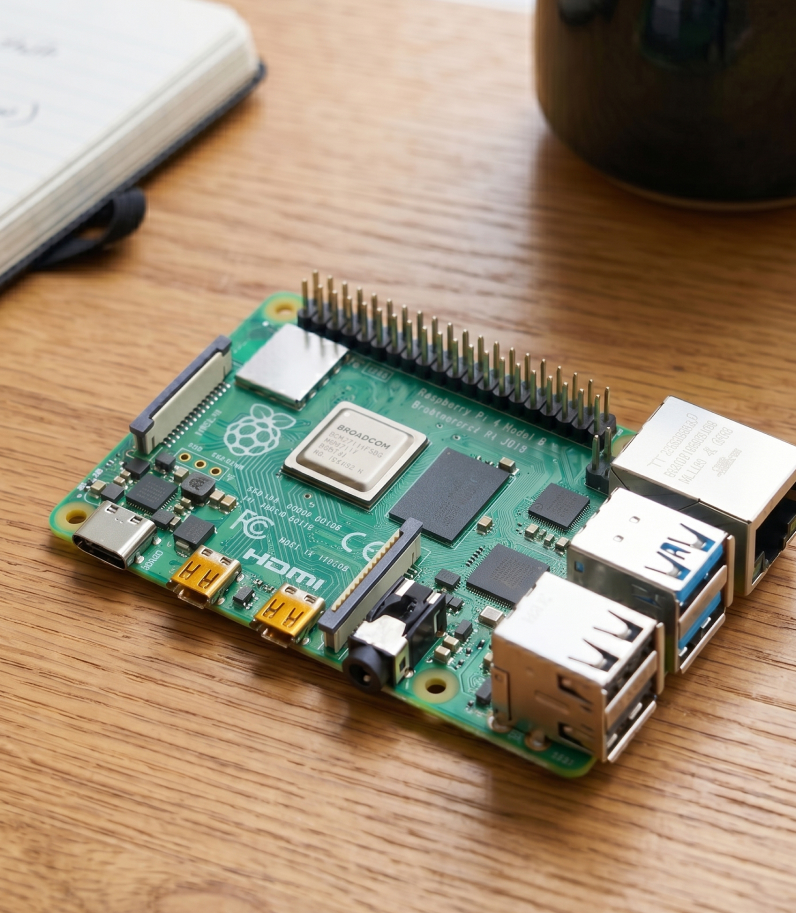 Raspberry Pi 4 on desk behind the mug